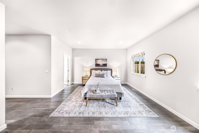 bedroom with dark wood-type flooring, visible vents, and baseboards