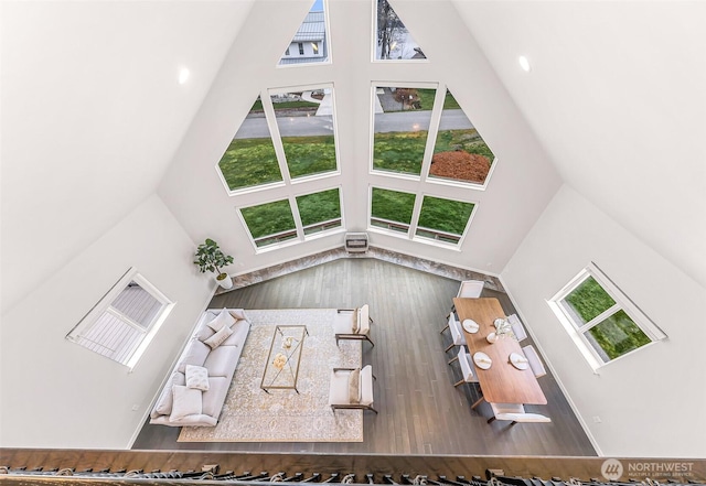 unfurnished living room featuring high vaulted ceiling