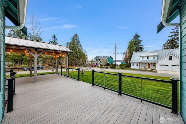 wooden terrace with a lawn and a gazebo