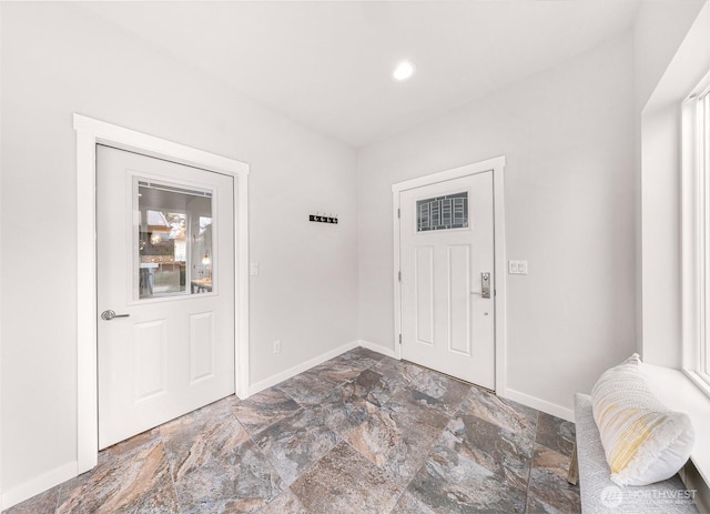 foyer entrance with recessed lighting, a healthy amount of sunlight, and baseboards