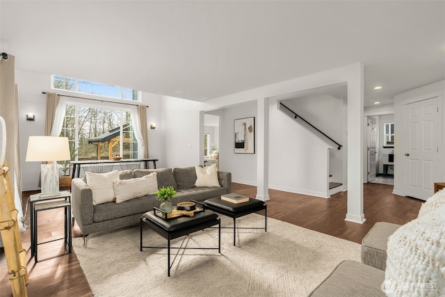 living area featuring recessed lighting, stairway, baseboards, and wood finished floors