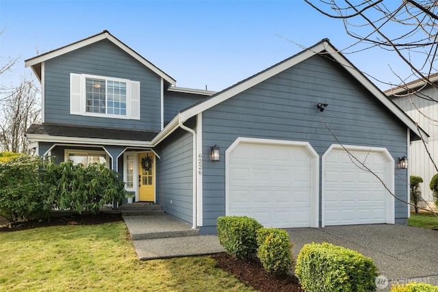 view of front of property with a garage, driveway, and a front lawn