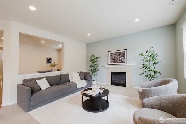 living room with carpet, baseboards, a premium fireplace, and recessed lighting