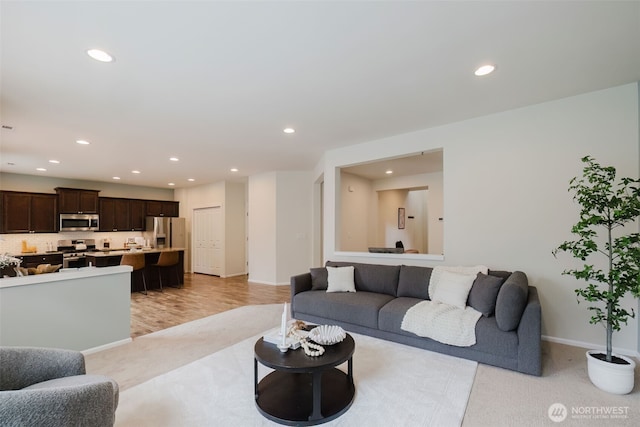 living room with baseboards and recessed lighting