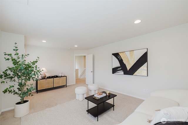 carpeted living area with baseboards and recessed lighting