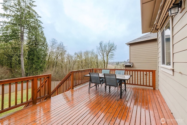 wooden deck featuring outdoor dining area