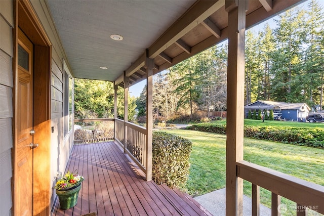 deck with covered porch and a yard