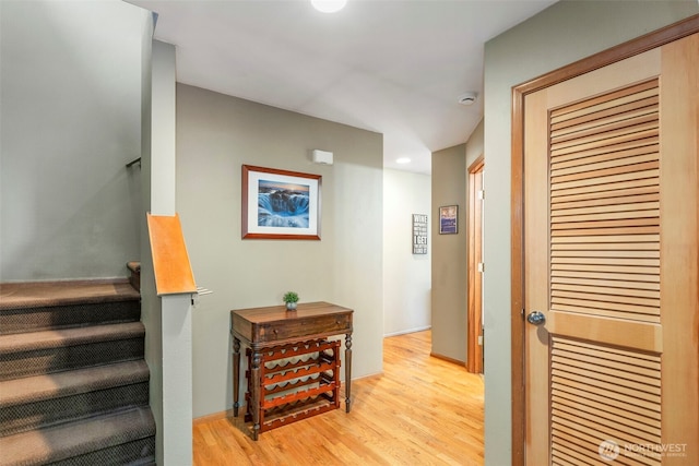 stairway featuring baseboards and wood finished floors