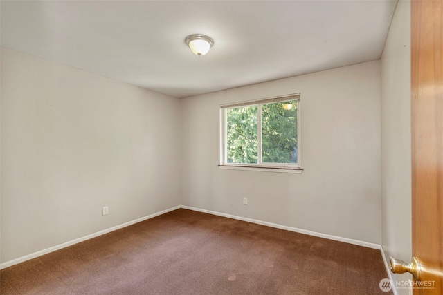 carpeted empty room with baseboards