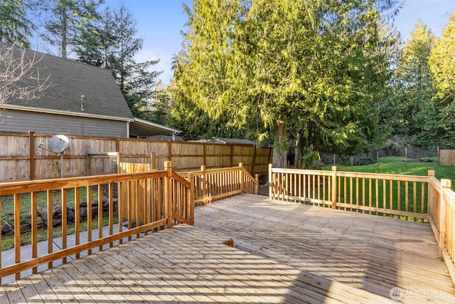 wooden deck featuring fence and a lawn