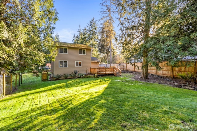 view of yard featuring a fenced backyard and a deck