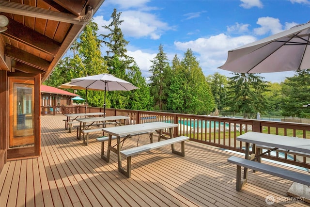 wooden deck featuring fence and outdoor dining area