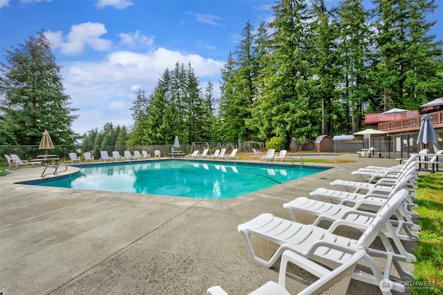 pool featuring fence and a patio