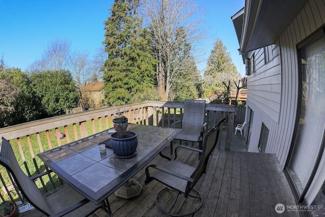 deck with outdoor dining area