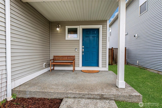 view of exterior entry with fence