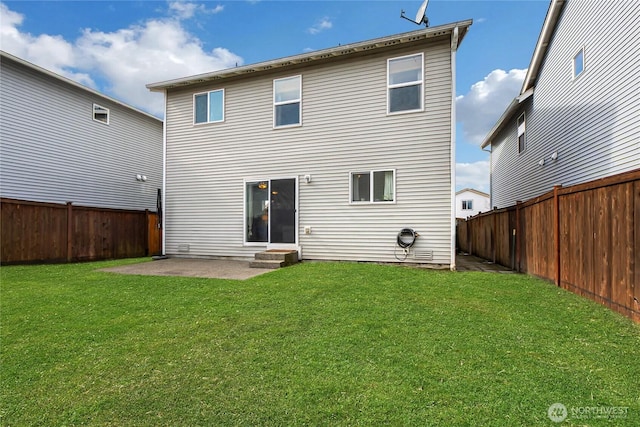 rear view of house with entry steps, a fenced backyard, a patio, and a yard