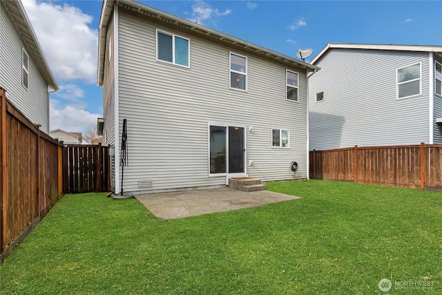 rear view of property with a fenced backyard, entry steps, a patio, and a yard