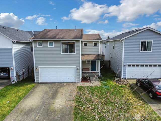 exterior space with an attached garage, a yard, and driveway