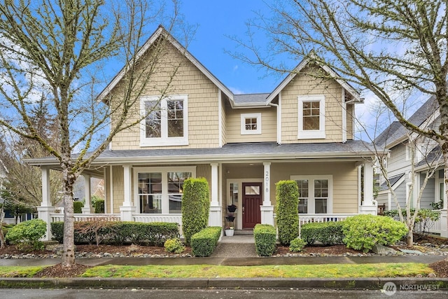 craftsman inspired home with a porch and roof with shingles