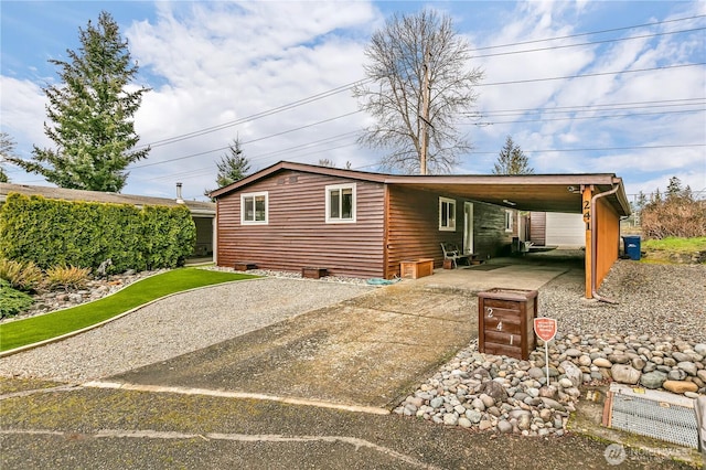 view of front of house featuring an attached carport and concrete driveway