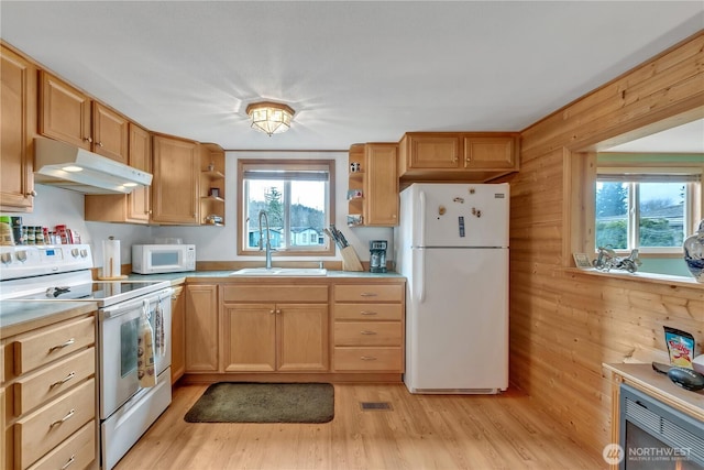 kitchen featuring white appliances, a healthy amount of sunlight, under cabinet range hood, open shelves, and a sink