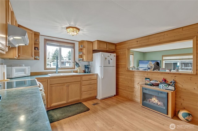 kitchen featuring white appliances, wooden walls, light wood-type flooring, under cabinet range hood, and open shelves