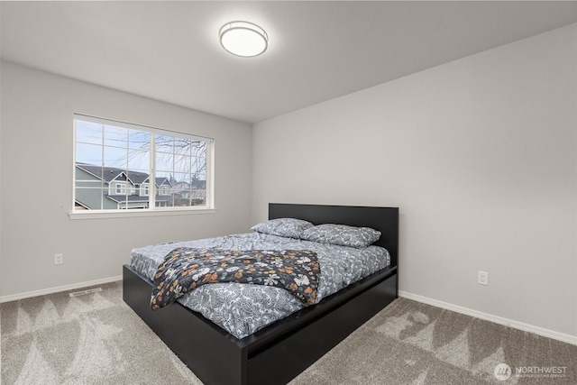 bedroom with carpet, visible vents, and baseboards