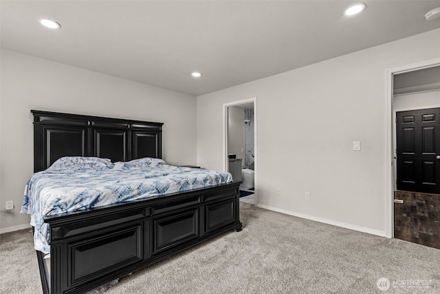 bedroom with baseboards, recessed lighting, connected bathroom, and light colored carpet