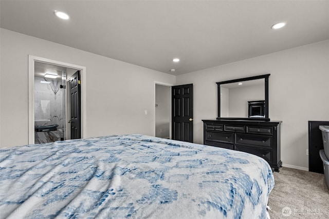 bedroom featuring ensuite bath, recessed lighting, baseboards, and light colored carpet