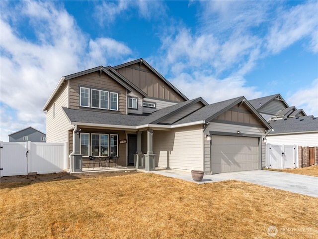 craftsman inspired home with board and batten siding, a front yard, and a gate