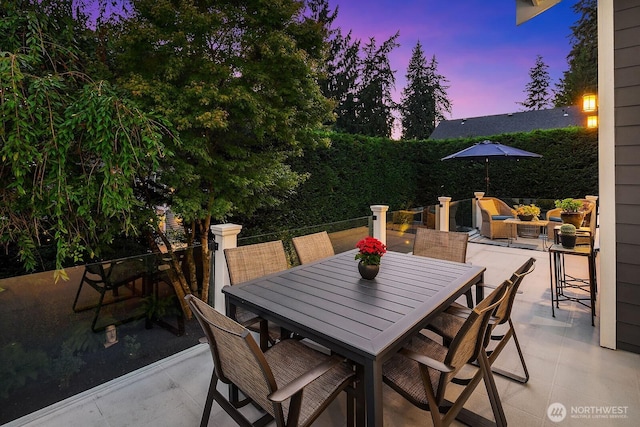 patio terrace at dusk with outdoor dining area