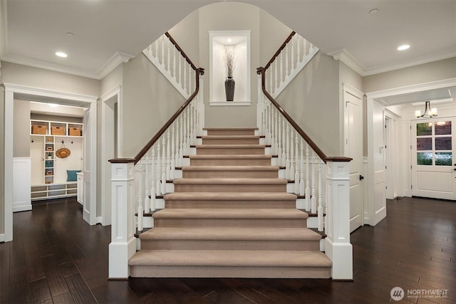stairway featuring hardwood / wood-style flooring, crown molding, a chandelier, and recessed lighting