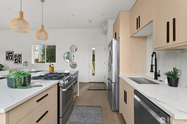 kitchen featuring stainless steel appliances, a sink, hanging light fixtures, light brown cabinetry, and tasteful backsplash