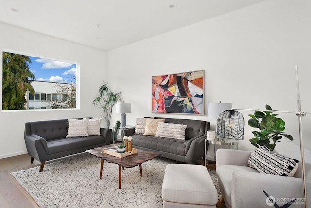 living area featuring light wood finished floors and baseboards