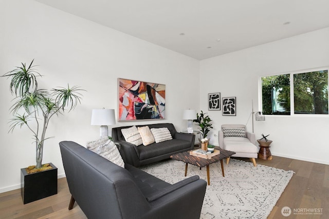 living area featuring baseboards and wood finished floors