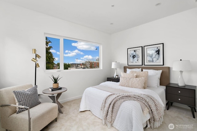 bedroom featuring light carpet and baseboards