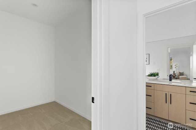 bathroom featuring baseboards and vanity