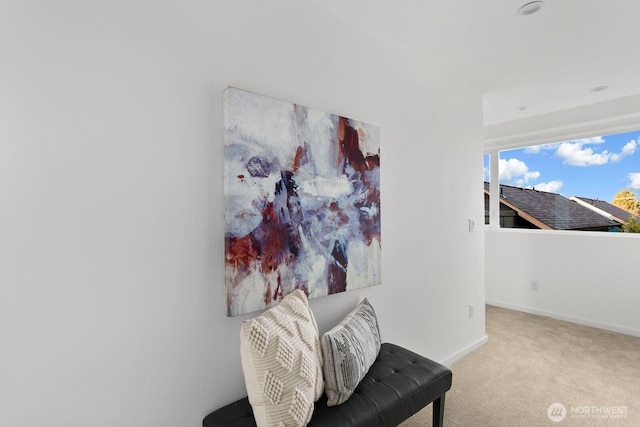 sitting room with light carpet and baseboards