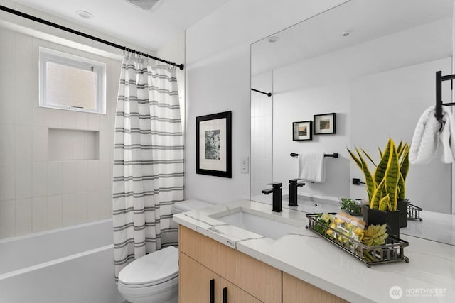 bathroom with vanity, toilet, and shower / bath combo with shower curtain