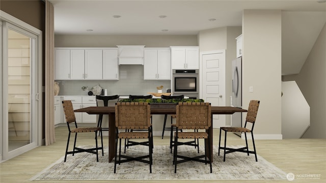 kitchen featuring stainless steel appliances, white cabinetry, baseboards, light wood finished floors, and tasteful backsplash