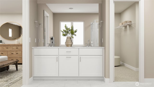 full bathroom featuring double vanity, baseboards, and a sink