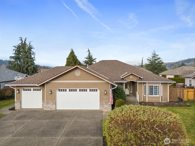 single story home featuring a shingled roof, concrete driveway, an attached garage, fence, and brick siding