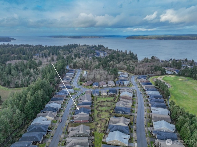 drone / aerial view with a water view and a residential view