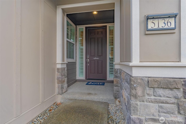 doorway to property with stone siding