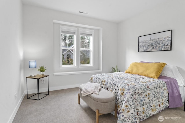 bedroom featuring light carpet, visible vents, and baseboards