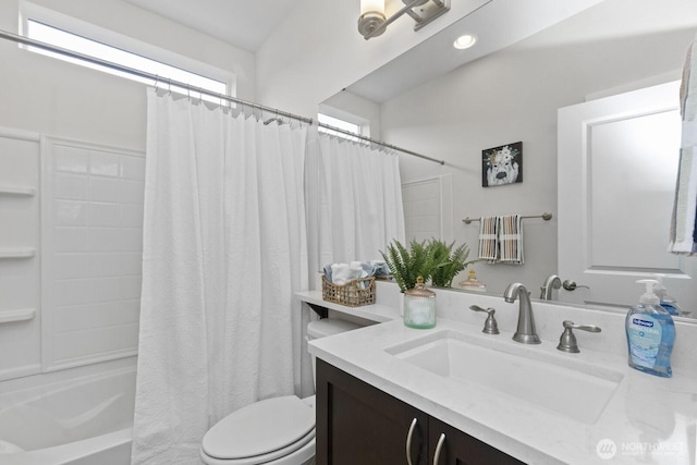 bathroom featuring toilet, shower / tub combo, and vanity