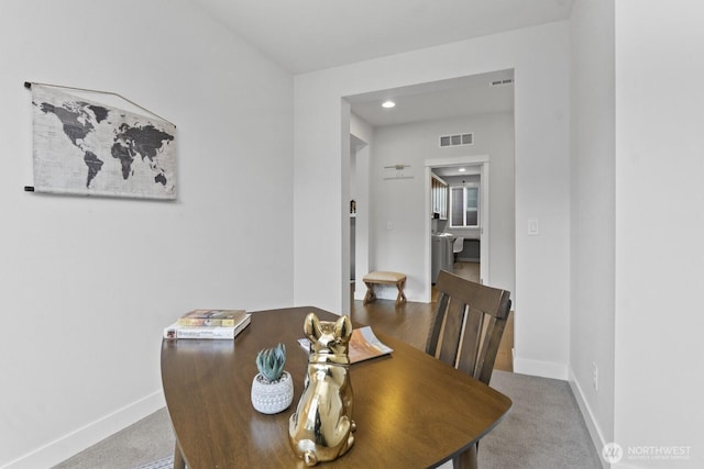 dining area with carpet, visible vents, and baseboards