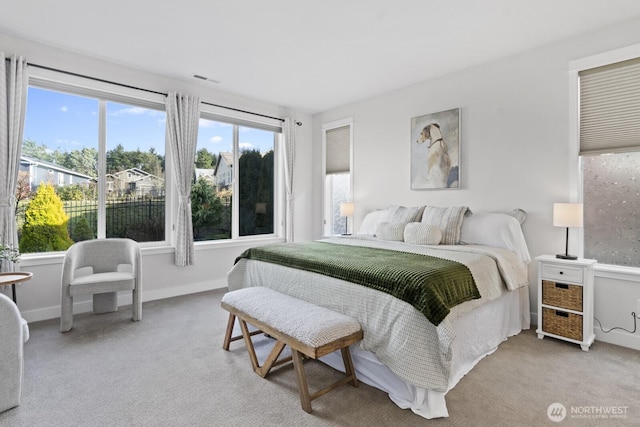 bedroom featuring light carpet, visible vents, and baseboards