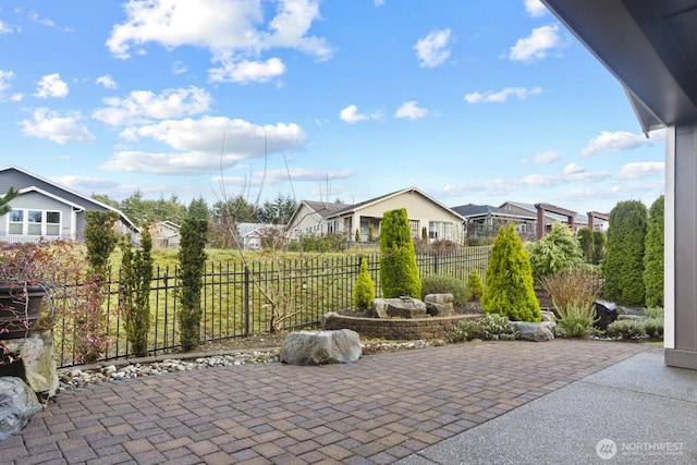 view of patio / terrace with a residential view and fence