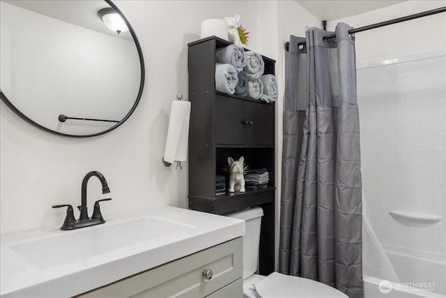 full bathroom with vanity, shower / bath combo with shower curtain, and toilet